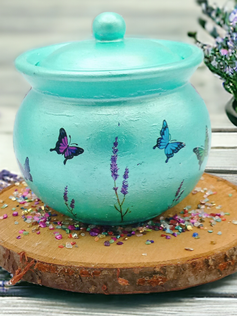 a handmade ceramic pot is painted in mint, with images of lavender and butterflies 